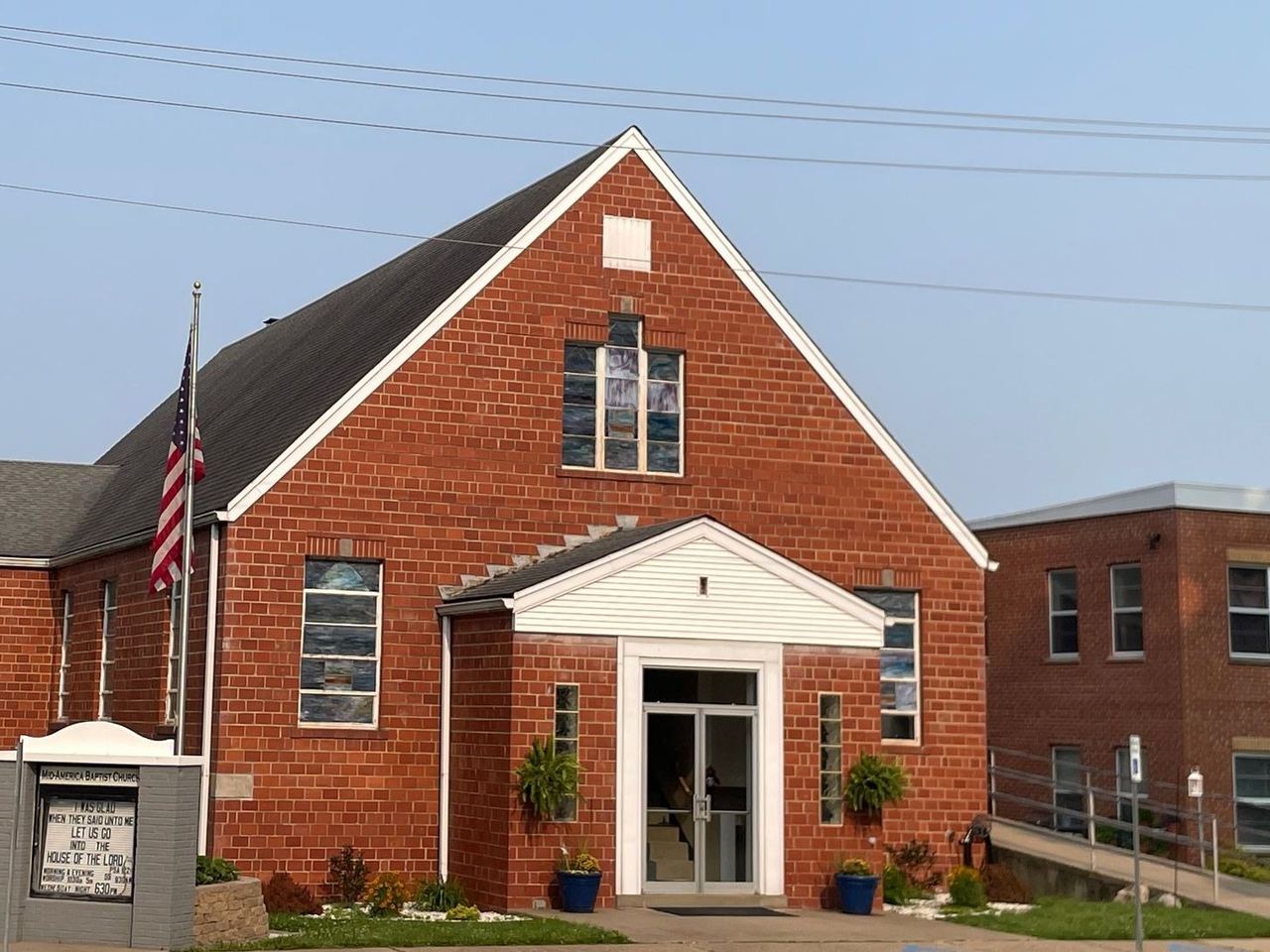 The Mid-America Baptist Church building, a red-brick church with a white entrance on 2nd Street