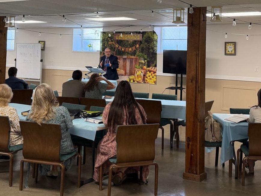 Church members sharing a meal at long tables in the fellowship hall
