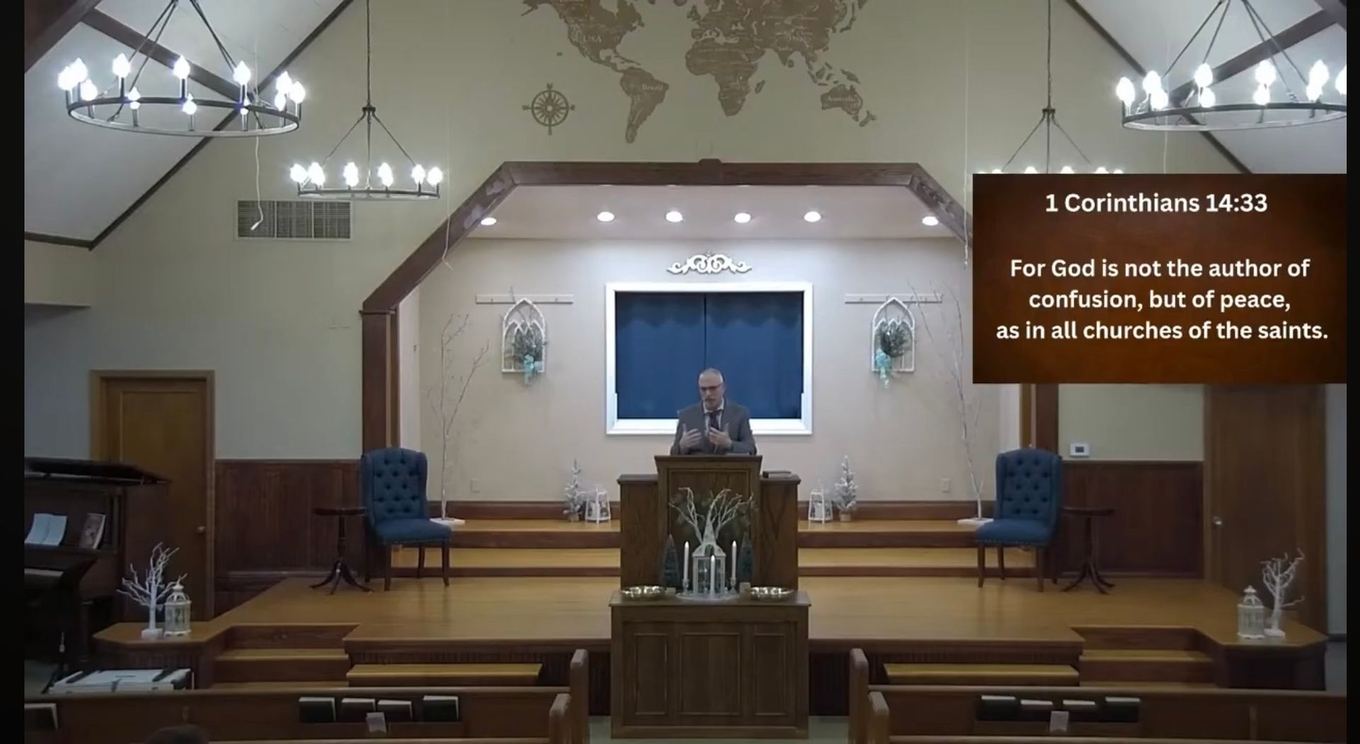 Pastor Leonard preaching from the pulpit during a Sunday service